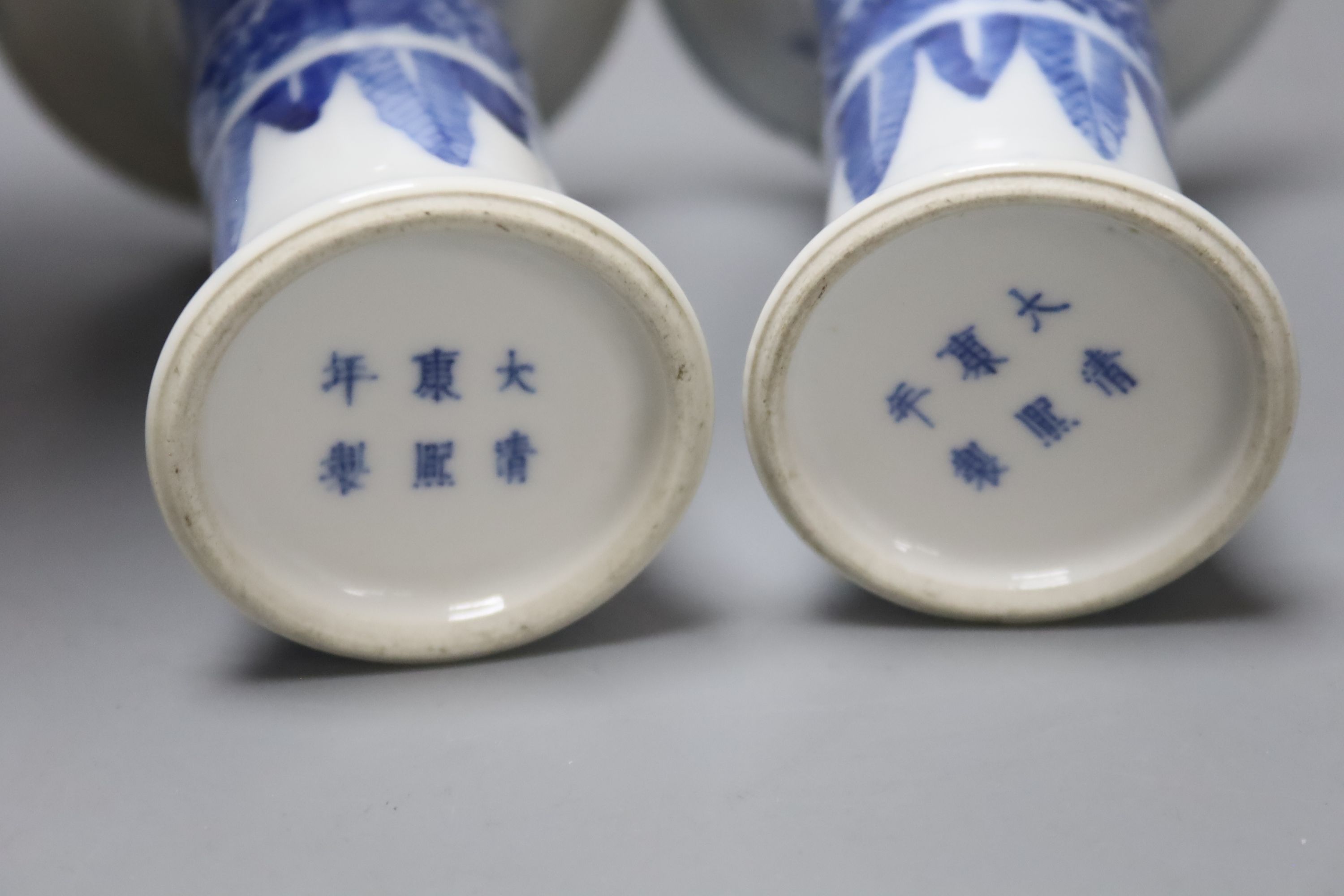 A pair of Chinese blue and white small beaker vases, Kangxi mark but c.1900, height 12cm